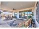 Relaxing covered patio with seating area and ceiling fan at 1238 W Silver Creek Ln, San Tan Valley, AZ 85140