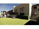 Landscaped backyard with lush lawn, stairs, and a dog at 13192 E Cibola Rd # 26, Scottsdale, AZ 85259