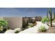 Modern desert home with clean lines, light-colored brick, and a landscaped walkway at 13192 E Cibola Rd # 26, Scottsdale, AZ 85259