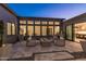 Spacious backyard patio with a modern fire pit, comfortable seating, and seamless indoor-outdoor living through large sliding doors at 13238 E Ranch Gate Rd, Scottsdale, AZ 85255