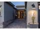 Inviting front entrance with a modern door, stylish planters, and exterior lighting that highlights the home's address at 13238 E Ranch Gate Rd, Scottsdale, AZ 85255