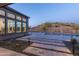 Resort-style backyard pool area with a desert landscape, custom lighting, and views of the hillside terrain at 13238 E Ranch Gate Rd, Scottsdale, AZ 85255