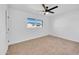 Well-lit bedroom with a ceiling fan and neutral carpeting at 1387 N 44Th St, Phoenix, AZ 85008