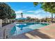 Community pool with a shaded seating area and surrounding landscaping at 1387 N 44Th St, Phoenix, AZ 85008