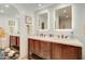 Modern bathroom with double vanity, lighted mirrors, and wood cabinets at 14228 N Yerba Buena Way, Fountain Hills, AZ 85268