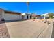 Front view of a tan house with a two-car garage and a gravel driveway at 14228 N Yerba Buena Way, Fountain Hills, AZ 85268