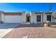 Tan stucco house with a brown door and a gravel yard at 14228 N Yerba Buena Way, Fountain Hills, AZ 85268