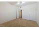 Spacious carpeted bedroom with ceiling fan and ample closet space at 14422 W Via Tercero --, Sun City West, AZ 85375