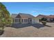 Rear view of single story house with gravel yard at 14422 W Via Tercero --, Sun City West, AZ 85375