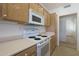 Kitchen features white appliances and wood cabinets at 14422 W Via Tercero --, Sun City West, AZ 85375