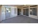 Covered patio with screened enclosure and access to backyard at 14422 W Via Tercero --, Sun City West, AZ 85375