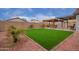 Landscaped backyard featuring artificial turf and pergola at 14805 W Caribbean Ln, Surprise, AZ 85379