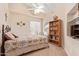 Cozy bedroom with a bookshelf and a ceiling fan at 14805 W Caribbean Ln, Surprise, AZ 85379