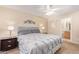 Main bedroom with gray bedding and ensuite bathroom at 14805 W Caribbean Ln, Surprise, AZ 85379