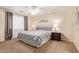 Main bedroom with gray bedding and ceiling fan at 14805 W Caribbean Ln, Surprise, AZ 85379