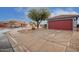 Front view of a house with red garage door and a tree in the front yard at 14805 W Caribbean Ln, Surprise, AZ 85379