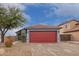 House exterior featuring a red garage door and well-maintained landscaping at 14805 W Caribbean Ln, Surprise, AZ 85379