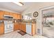 Bright kitchen with wood cabinets, granite counters, and tile floors at 14805 W Caribbean Ln, Surprise, AZ 85379