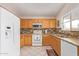 White appliances and light wood cabinets in this kitchen at 14805 W Caribbean Ln, Surprise, AZ 85379