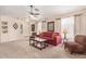 Spacious living room with a red couch and large windows at 14805 W Caribbean Ln, Surprise, AZ 85379