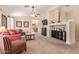 Living room with red couch, carpet, and built-in shelving at 14805 W Caribbean Ln, Surprise, AZ 85379