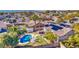 Aerial view of a house with solar panels and a pool in a residential neighborhood at 14905 W Dovestar Dr, Surprise, AZ 85374