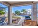 Covered patio overlooking a pool and fire pit area at 14905 W Dovestar Dr, Surprise, AZ 85374