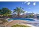 Pool area with lounge chairs and a lush green lawn at 14905 W Dovestar Dr, Surprise, AZ 85374