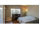 Bright bedroom with a queen-size bed and wood flooring at 14905 W Dovestar Dr, Surprise, AZ 85374