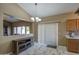 Bright dining area with tile floors and access to the backyard at 14905 W Dovestar Dr, Surprise, AZ 85374