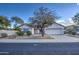 Single-story home with a two-car garage and nicely landscaped front yard at 14905 W Dovestar Dr, Surprise, AZ 85374