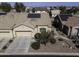 Aerial view of a house with solar panels, double garage, and desert landscaping at 1548 E Melrose Dr, Casa Grande, AZ 85122