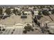 Aerial view showing a house with solar panels, a driveway, and surrounding homes at 1548 E Melrose Dr, Casa Grande, AZ 85122