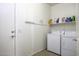 Laundry room with washer, dryer, and shelving at 1548 E Melrose Dr, Casa Grande, AZ 85122