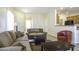 Living room featuring a sofa, loveseat, and a view into the kitchen at 1548 E Melrose Dr, Casa Grande, AZ 85122