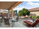 Relaxing backyard patio with seating area and citrus tree at 16148 W Starlight Dr, Surprise, AZ 85374