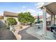 Landscaped backyard with patio, seating, and a citrus tree at 16148 W Starlight Dr, Surprise, AZ 85374