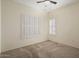 Bright bedroom featuring plantation shutters and ceiling fan at 16148 W Starlight Dr, Surprise, AZ 85374