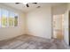 Charming bedroom with plantation shutters and access to hallway at 16148 W Starlight Dr, Surprise, AZ 85374