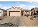 Single story home with two car garage and desert landscaping at 16148 W Starlight Dr, Surprise, AZ 85374