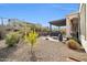 Landscaped backyard with gravel and a covered patio area at 18961 N 264Th Ave, Buckeye, AZ 85396