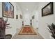 Bright entryway with a red rug and artwork on the walls at 18961 N 264Th Ave, Buckeye, AZ 85396