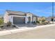 Single-story home with gray garage door, landscaping, and mountain views at 18961 N 264Th Ave, Buckeye, AZ 85396