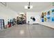 Spacious garage with golf cart, storage, and wall art at 18961 N 264Th Ave, Buckeye, AZ 85396