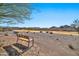 Relaxing bench overlooking a scenic golf course with mountain views at 18961 N 264Th Ave, Buckeye, AZ 85396