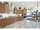 Kitchen with wood cabinets, granite countertops, and a large sink at 18961 N 264Th Ave, Buckeye, AZ 85396