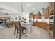 Modern kitchen with wood cabinets, granite counters, and stainless steel appliances at 18961 N 264Th Ave, Buckeye, AZ 85396