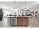 Kitchen island with granite countertop and stainless steel dishwasher at 18961 N 264Th Ave, Buckeye, AZ 85396