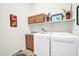 Convenient laundry room with washer, dryer, and overhead cabinets at 18961 N 264Th Ave, Buckeye, AZ 85396