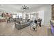 Open living area with grey couch and view into kitchen at 18961 N 264Th Ave, Buckeye, AZ 85396